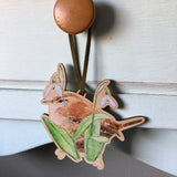 watercolour illustration of wren and snowdrop flowers printed on wooden decoration displayed hanging from  drawer handle