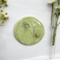 Snail and forget me not ceramic wall plate
