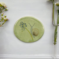 Snail and forget me not ceramic wall plate